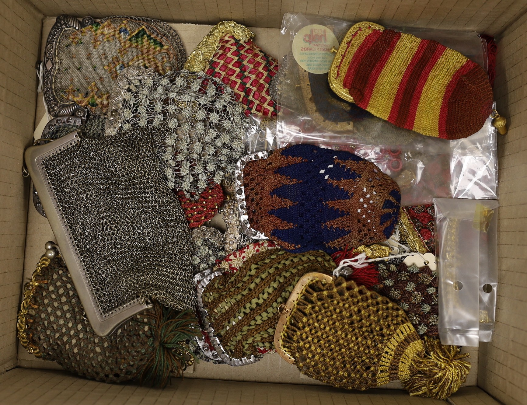 A plated chainmail purse, a metal thread misers purse and a collection of twenty three mixed knitted, crochet and cut steel 19th century purses